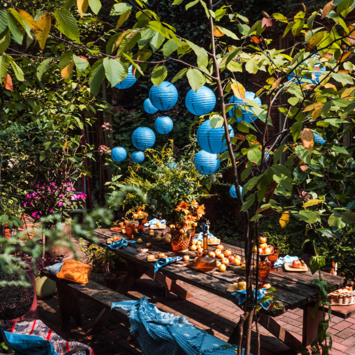 Blue paper lanterns hanging above a party table