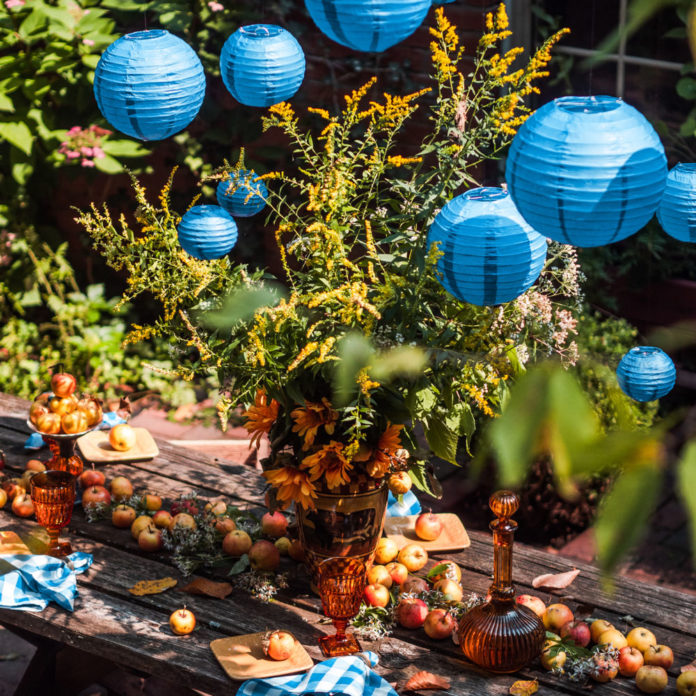 Blue paper lanterns hanging above a party table